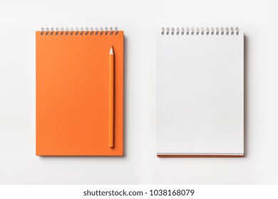 Design Concept - Top View Of Orange Spiral Notebook And Color Pencil Collection Isolated On White Background For Mockup