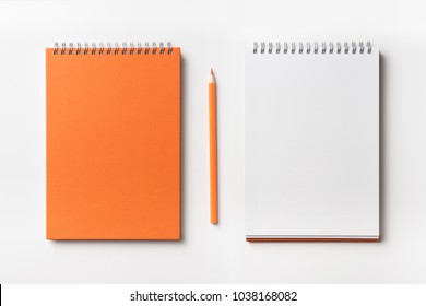 Design concept - Top view of orange spiral notebook and color pencil collection isolated on white background for mockup - Shutterstock ID 1038168082
