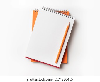 Design Concept - Top View Of Orange And Red Spiral Notebook And Color Pencil Collection Isolated On White Background For Mockup