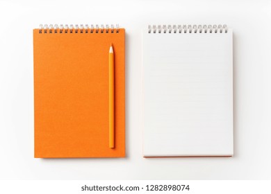 Design concept - Top view of orange spiral notebook, white page and pencil isolated on background for mockup - Powered by Shutterstock