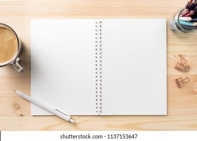 Design concept - Top view of lot of stationary, like black spiral notebook and wood mechanical pencil…etc on wood table background for mockup