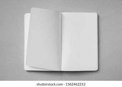 Design Concept - Top View Of White Notebook With Blank Open, Turn And Flipped Page On Grey Background For Mockup. Real Photo, Not 3D Render