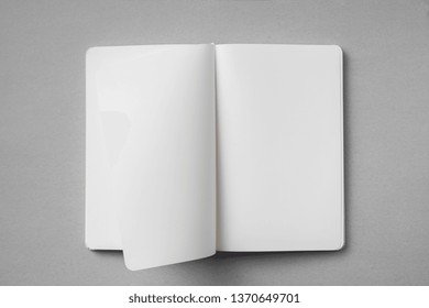 Design Concept - Top View Of White Notebook With Blank Open, Turn And Flipped Page On Grey Background For Mockup. Real Photo, Not 3D Render