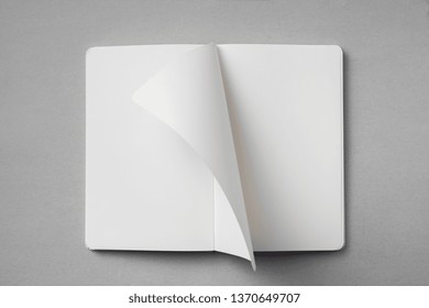 Design Concept - Top View Of White Notebook With Blank Open, Turn And Flipped Page On Grey Background For Mockup. Real Photo, Not 3D Render