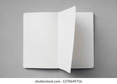 Design concept - top view of white notebook with blank open, turn and flipped page on grey background for mockup. real photo, not 3D render - Powered by Shutterstock