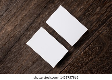 Design Concept - Top View Of White Business Card On Wood Floor Background For Mockup