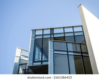 Design and construction of a modern building. Glass and concrete. Building of unusual geometric shape. Exterior. - Powered by Shutterstock