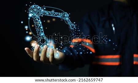 A design engineer holds a low poly or polygon robotic arm in hand after a successful design. The manufacturing technology of the future, artificial intelligence or AI in the modern industrial sector.