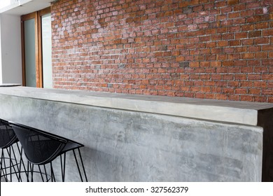 Design Of Interior, Counter Bar Made From Cement With Iron Seat Bar Stool And Brick Wall Background