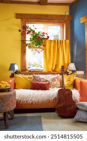design interior of a creative workshop in yellow and blue tones, with an orange sofa and colorful cushions 