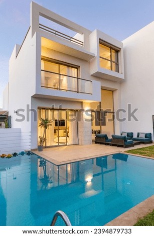 Design luxury villa, garden and pool with plants and relaxation area, trendy white, blue and green colors
