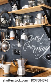Design of modern kitchen in loft and rustic style. Geyser aluminum coffee maker on the background of a black wall with the chalk 