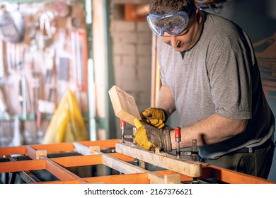 Design people person factory repair shop concept. Portrait of serious brutal master using mallet and chisel