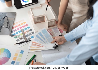 Design Planning Session. Professionals analyzing color swatches and architectural models. - Powered by Shutterstock - Get 15% off with code: PIKWIZARD15