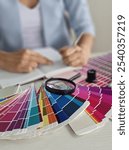 Design professional evaluating color palettes and sketching concepts at a bright workspace