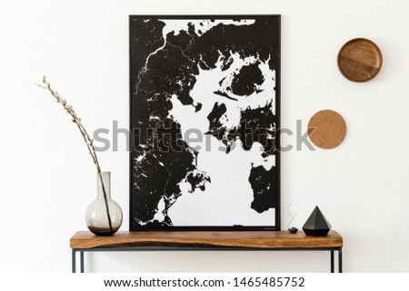 Design scandinavian interior of living room with wooden console, rings on the wall, black vases , hourglass and elegant personal accessories. Stylish mock up poster map. Modern home decor. Template. 