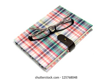 Design Of Spiral Bound  Notebook Cover And Glasses  On White Background