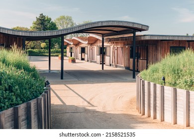 design stables in a horse education center - modern horse farm with wooden and steel structures - daylight - Shutterstock ID 2158521535