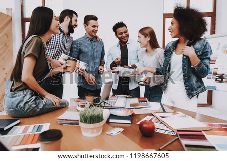 Design Studio. Multi-Ethnic. Project. Creative. Look. Young People. Different Nationalities. Designers. Young Specialists. Choose Colors for Design. Teamwork. Discussion. Brainstorming. Workplace.