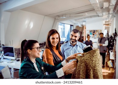 Design team looking at fashion samples in workshop - Powered by Shutterstock