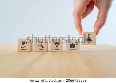 Design thinking process concept. Hand hold wooden cube with icon illustrate empathize, define, ideate, prototype, test. White background. Guide for innovation, creativity and a change of perspective.
