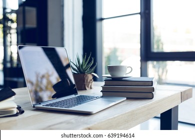 design of workplace with laptop and cup of coffee in home office - Shutterstock ID 639194614