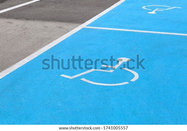 Designated Disabled car\
parking spaces reserved with blue painted, parking rules, special\
place, social care