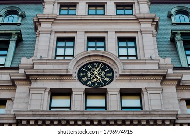 Designed clock placed on top of an architectural building