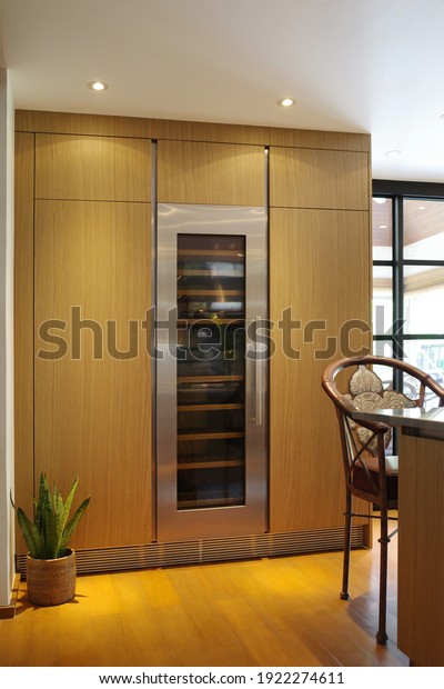 Designed kitchen\
with \
beautiful Wood kitchen ,Wine cooler built in tall cabinet\
kitchen, Plants, Wooden\
floor.