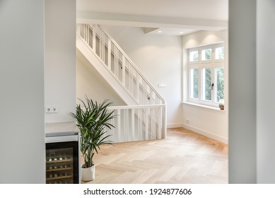 Designed in a minimalistic style staircase hall. Interior of luxury house stair hall