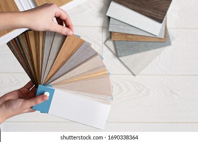 Designer Architect Holds A Palette Of Textures And Decor For A Wooden Floor Made Of Laminate And Vinyl. Interior Design. Planning For Repairs And Home Construction.