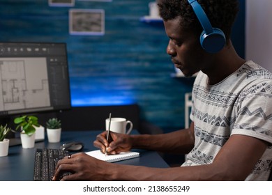 Designer Architect Wearing Headphones Analyzing Real Estate Blueprints Designing Building Prototype Working Remote From Home. Contractor Young Adult Developing Architectural Product