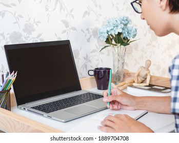 Designer or artist at work. Workplace interior - laptop, book, wooden artist's dummy, coloring pencils. Freelance. Home office.  - Powered by Shutterstock