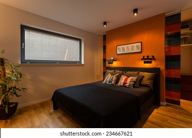 Designer Bedroom With Orange Wall And Color Cushions