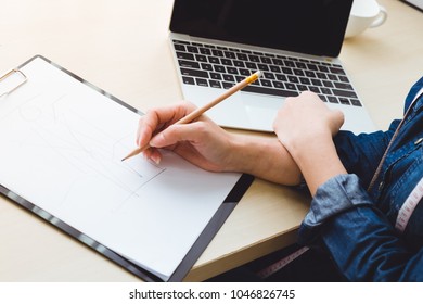 designer create idea fashion and sketch on paper with laptop, desk and measuring tape, designer concept - Powered by Shutterstock