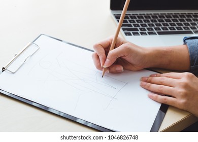 designer create idea fashion and sketch on paper with laptop and desk, designer concept - Powered by Shutterstock