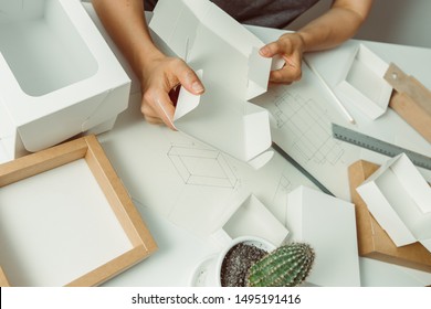 The Designer Creates A Mockup For Crafting Of Cardboard Ecological Packaging. Development A Model Paper Box For Branding. 