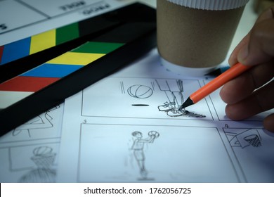 Designer Creative Drawing In Storyboard For Film Movie, Video Pre-production Process In Display Script Production. Design Shot Scene Layout With Paper Cup Coffee And Slate In Studio.Media Product Idea