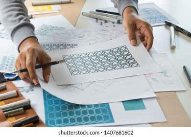 Designer designing drawing sketch pattern geometric flower seamless wallpaper fabric textile fashion industry. artistic design studio.