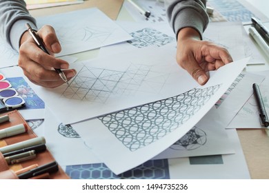 Designer designing drawing sketch pattern geometric flower seamless wallpaper fabric textile fashion industry. artistic design studio.