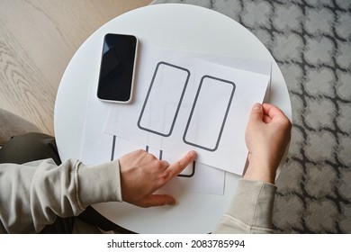 Designer is developing a UX mobile application wireframe. Sketch, prototype, framework, layout future app design for smartphone. UI and UX user interface and user experience designer. App development 