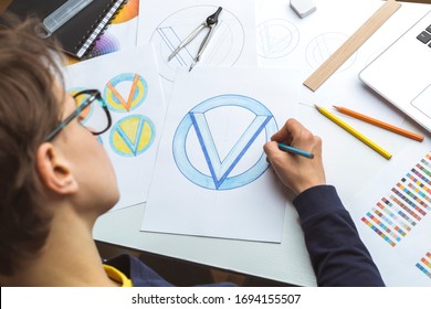 The Designer Draws Sketches Of The Brand Logo.