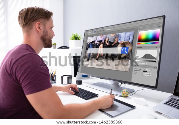 Designer Editing\
Photo On Computer In\
Office