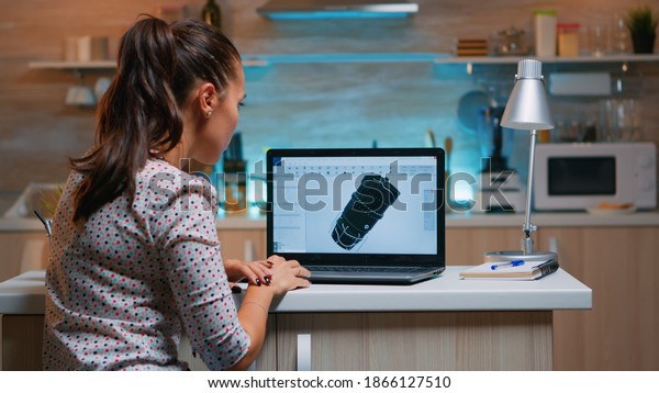Designer engineer analizing new prototype of 3D\
model of the plant working from home. Industrial female worker\
studying turbine idea on personal computer showing cad software on\
device display