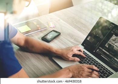 designer hand attending video conference with laptop computer and smart phone at desk in office - Shutterstock ID 469430318