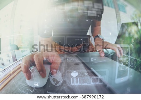 Designer hand working with laptop computer on wooden desk as responsive web design, work from home concept