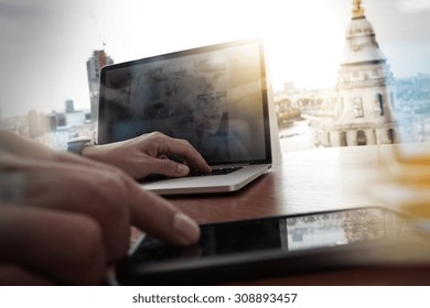 Designer Hand Working And Smart Phone And Laptop On Wooden Desk In Office With London City Background 