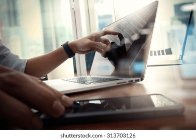 Designer Hand Working And Smart Phone And Laptop On Wooden Desk In Office With London City Background