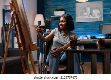 Designer illustration in wheelchair holding phone taking photo of personal drawing working at creative masterpiece in art atelier. Artist drawing vase using professional graphic pencil - Powered by Shutterstock