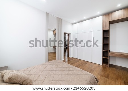Designer large, white wardrobe in the room for clothes. Bed for rest Foto d'archivio © 